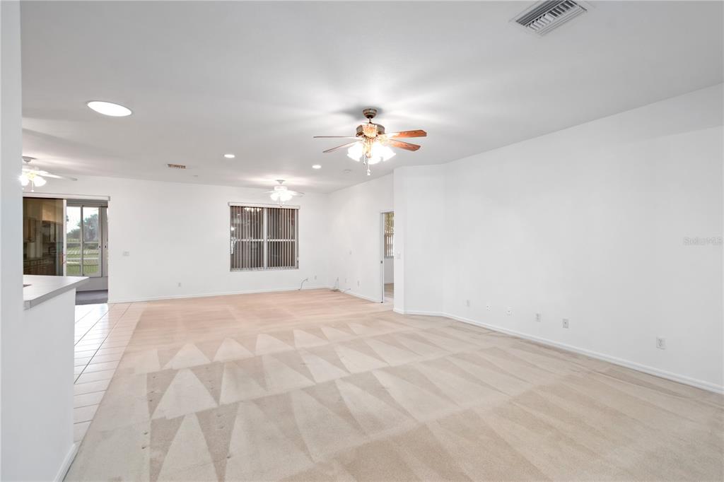 9441 Southwest 90th Street Ocala, FL 34481 - Photo 11 of 48 a view of an empty room with a ceiling fan