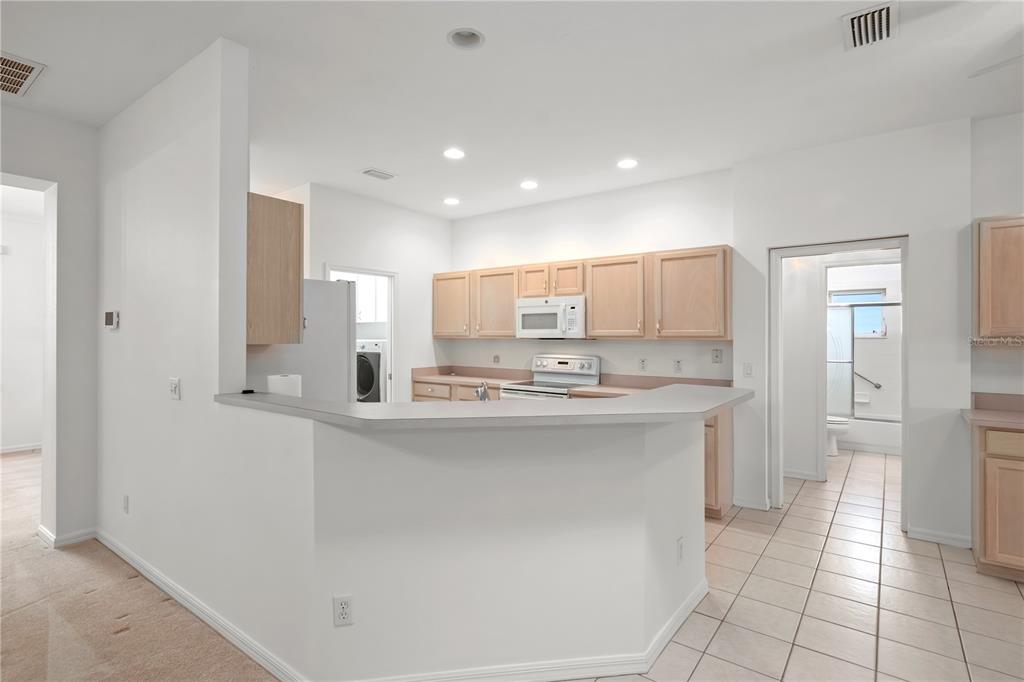 9441 Southwest 90th Street Ocala, FL 34481 - Photo 15 of 48 a kitchen with stainless steel appliances a sink stove and cabinets