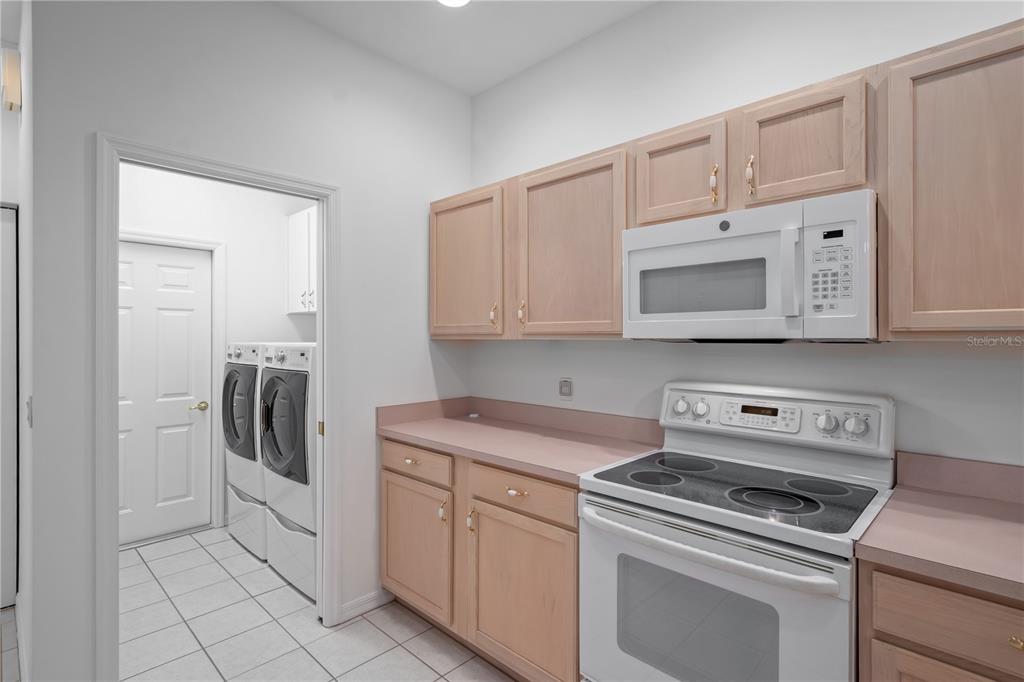 9441 Southwest 90th Street Ocala, FL 34481 - Photo 19 of 48 a kitchen with white cabinets and white appliances
