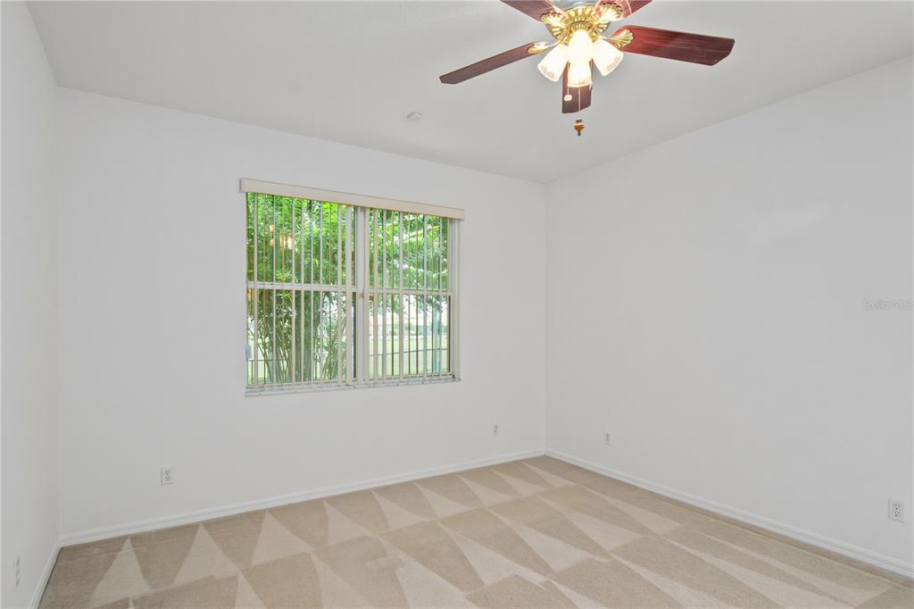 9441 Southwest 90th Street Ocala, FL 34481 - Photo 22 of 48 an empty room with a window and a fan