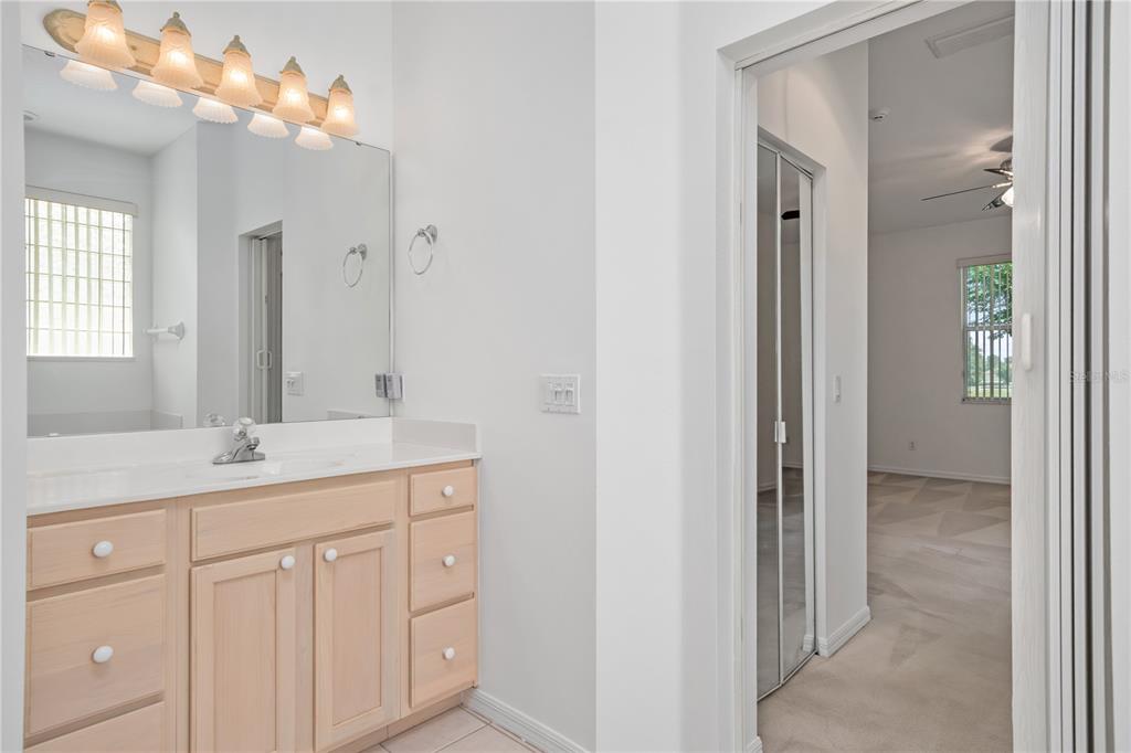 9441 Southwest 90th Street Ocala, FL 34481 - Photo 30 of 48 a bathroom with a double vanity sink and a mirror