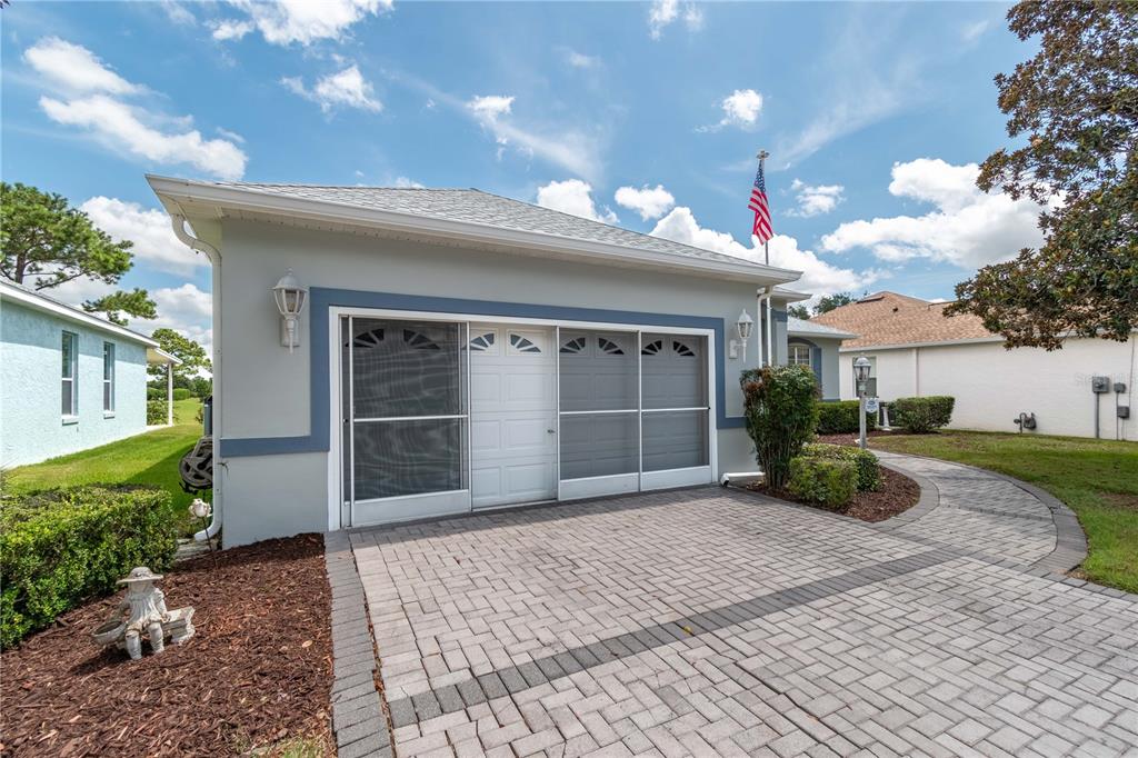 9441 Southwest 90th Street Ocala, FL 34481 - Photo 3 of 48 a view of a house with a yard and potted plants
