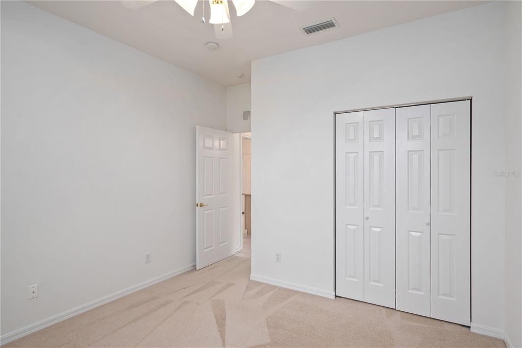 9441 Southwest 90th Street Ocala, FL 34481 - Photo 32 of 48 an empty room with a hallway