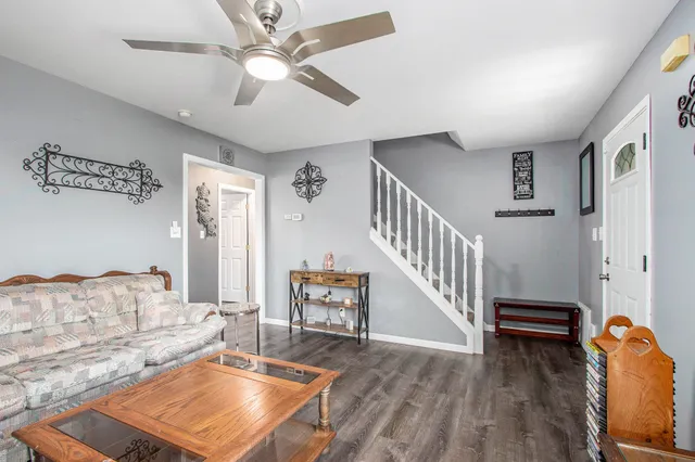 a living room with furniture and a dining table