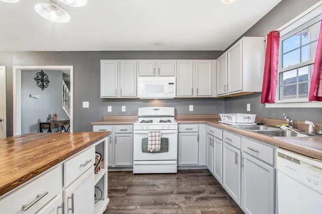 a kitchen with a sink stove and cabinets