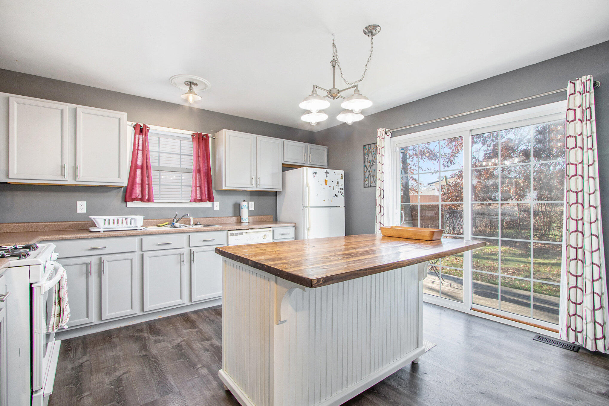 682 Dearborn Road, Unit A Valparaiso, IN 46385 - Photo 10 of 23 a kitchen with stainless steel appliances granite countertop a stove a sink dishwasher and a refrigerator with wooden floor
