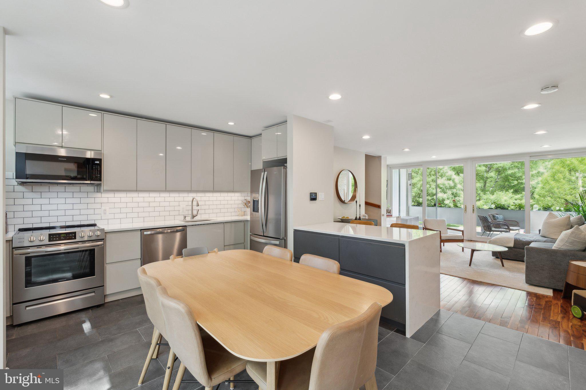 11599 Maple Ridge Road Reston, VA 20190 - Photo 1 of 38 a kitchen with a table chairs sink and cabinets