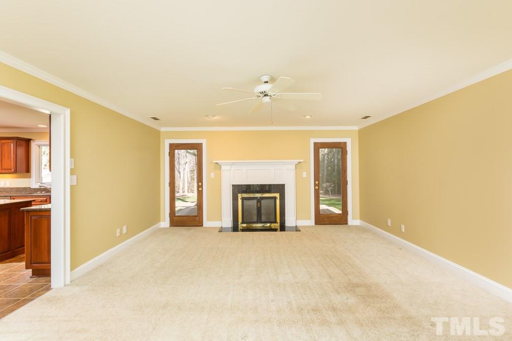 3120 Mt Vernon Church Road Raleigh, NC 27613 - Photo 3 of 9 a view of an empty room with a fireplace