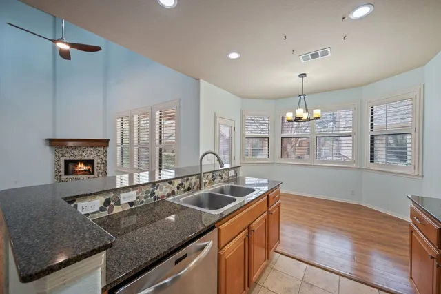 a kitchen with granite countertop a sink and a stove