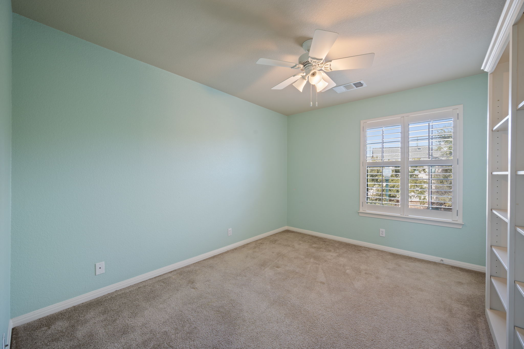 4229 John's Light Drive Austin, TX 78727 - Photo 19 of 27 an empty room with windows and chandelier fan