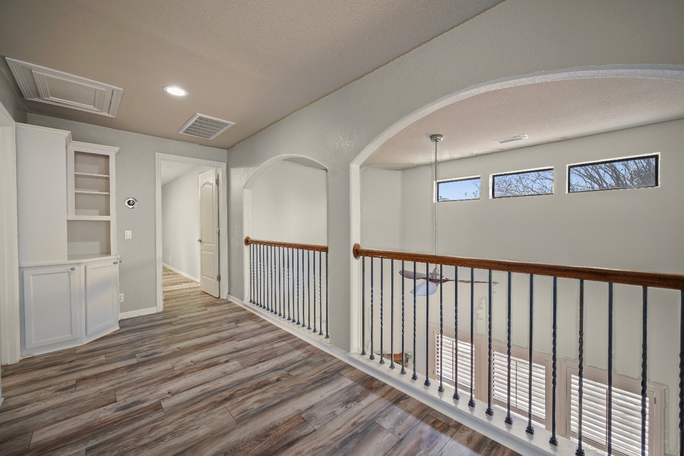 4229 John's Light Drive Austin, TX 78727 - Photo 20 of 27 a view of a hallway with wooden floor