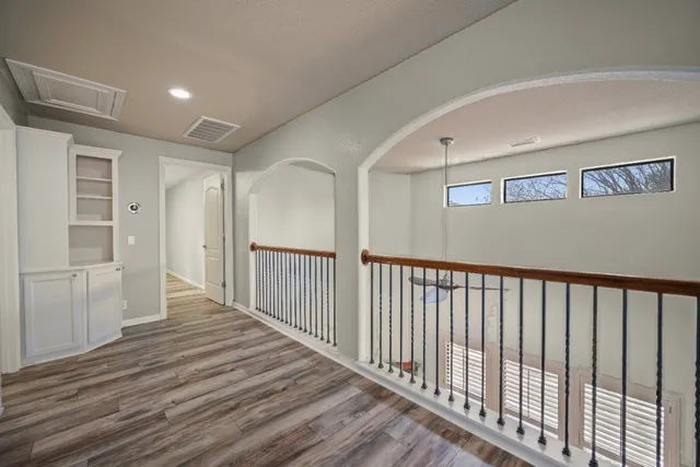 a view of a hallway with wooden floor