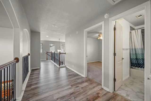 a view of a hallway with wooden floor