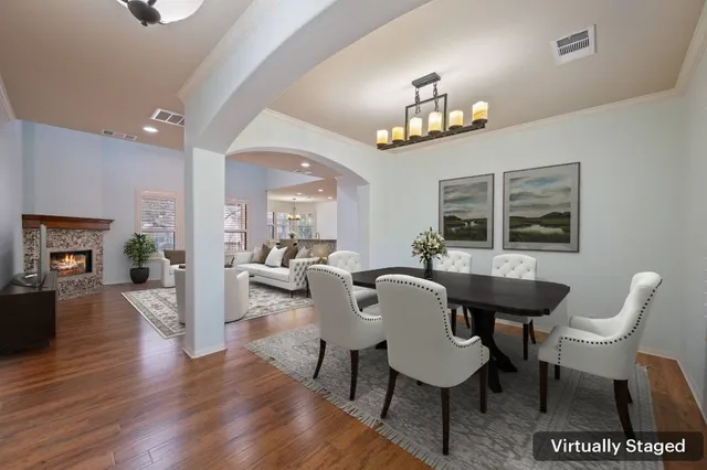 a view of a dining room with furniture a chandelier and wooden floor