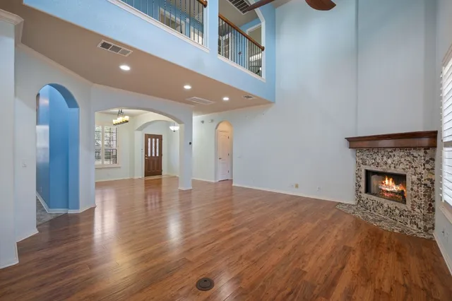 a view of a livingroom with wooden floor and a fireplace