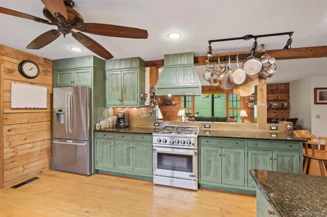 a kitchen with stainless steel appliances granite countertop a stove and a refrigerator