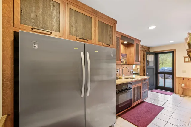 a kitchen with stainless steel appliances a refrigerator sink and cabinets