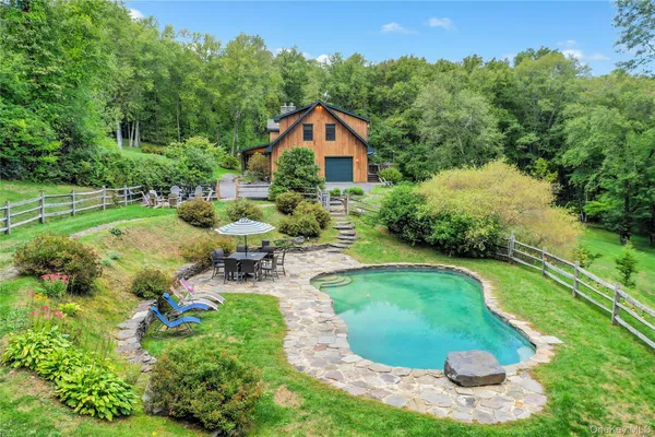 a swimming pool with outdoor seating and yard