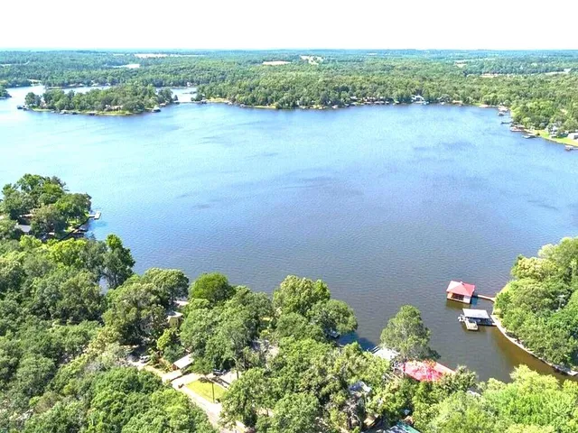 an aerial view of a houses with a lake view