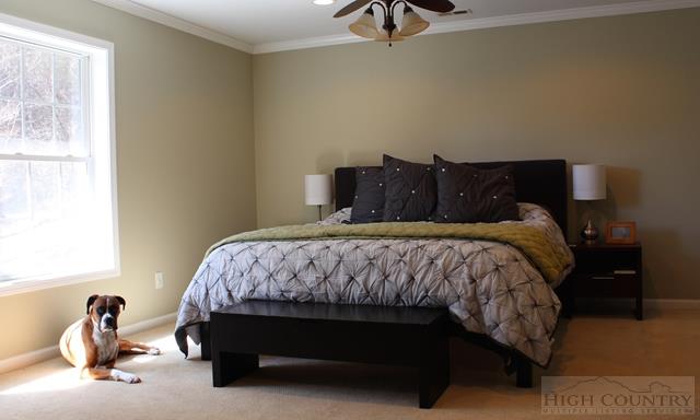 115 Martys Road Boone, NC 28607 - Photo 14 of 43 a bed sitting in a bedroom next to a window