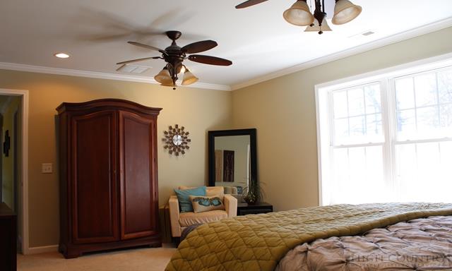 115 Martys Road Boone, NC 28607 - Photo 15 of 43 a bedroom with a bed and a chandelier