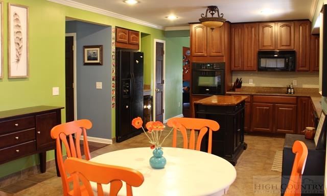 115 Martys Road Boone, NC 28607 - Photo 34 of 43 a dining room with stainless steel appliances kitchen island granite countertop a dining table and chairs