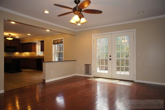 115 Martys Road Boone, NC 28607 - Photo 5 of 43 a view of an empty room with wooden floor and a kitchen