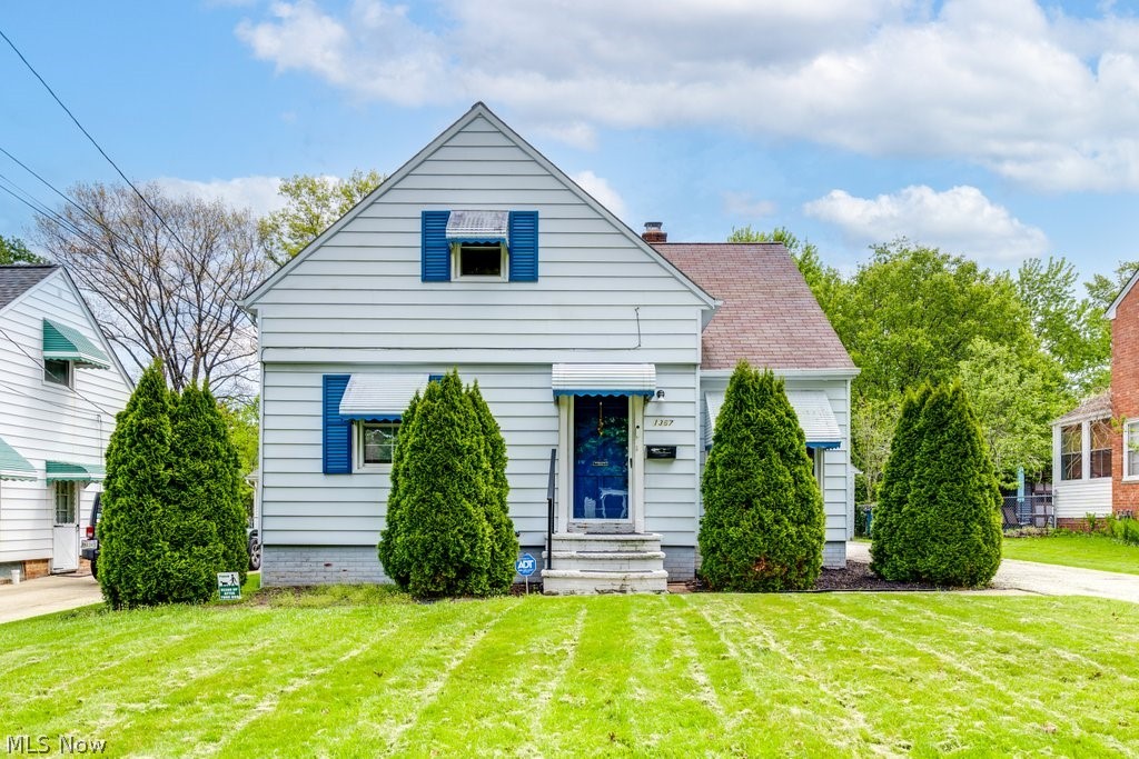 1367 Churchill Road Lyndhurst, OH 44124 - Photo 1 of 30 White siding exterior with blue window shutters and coordinating awnings
