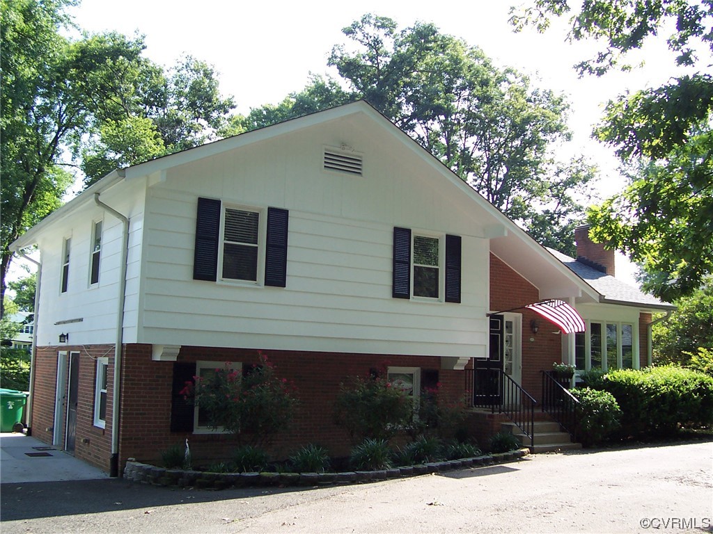 8410 Gaylord Road Henrico, VA 23229 - Photo 1 of 17 a front view of a house with yard and trees around