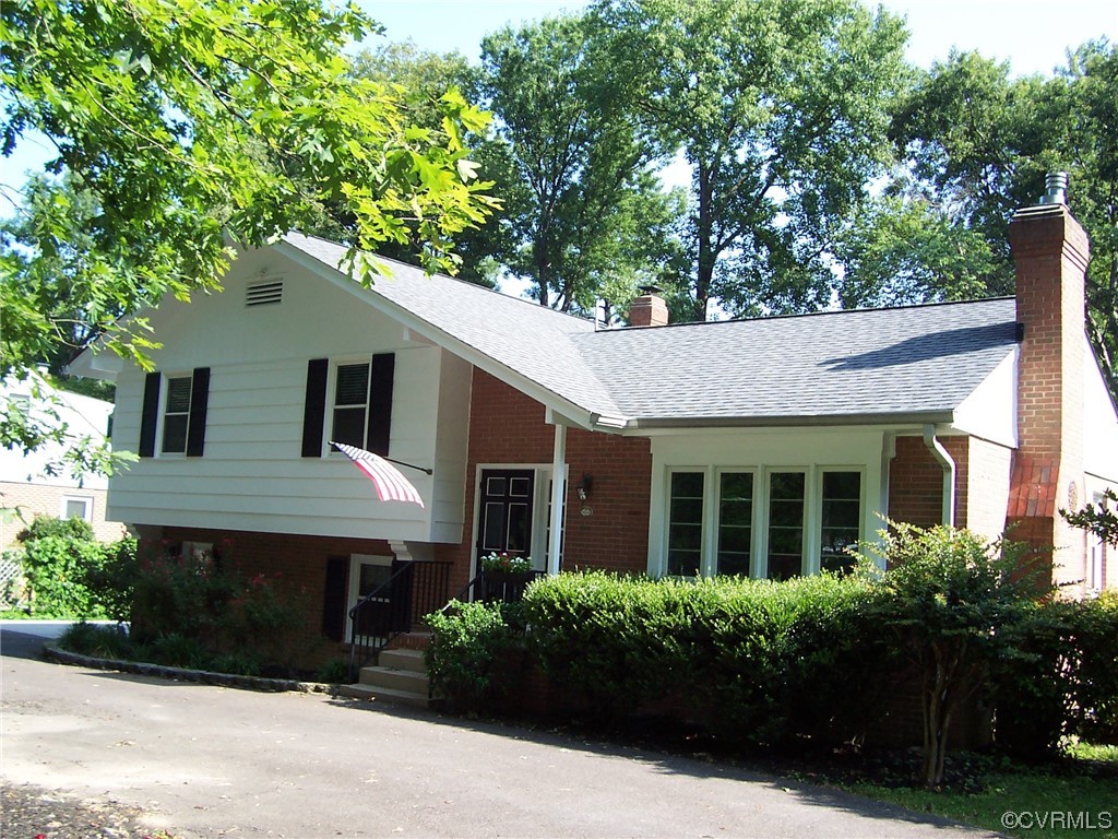 8410 Gaylord Road Henrico, VA 23229 - Photo 2 of 17 a front view of a house with a garden