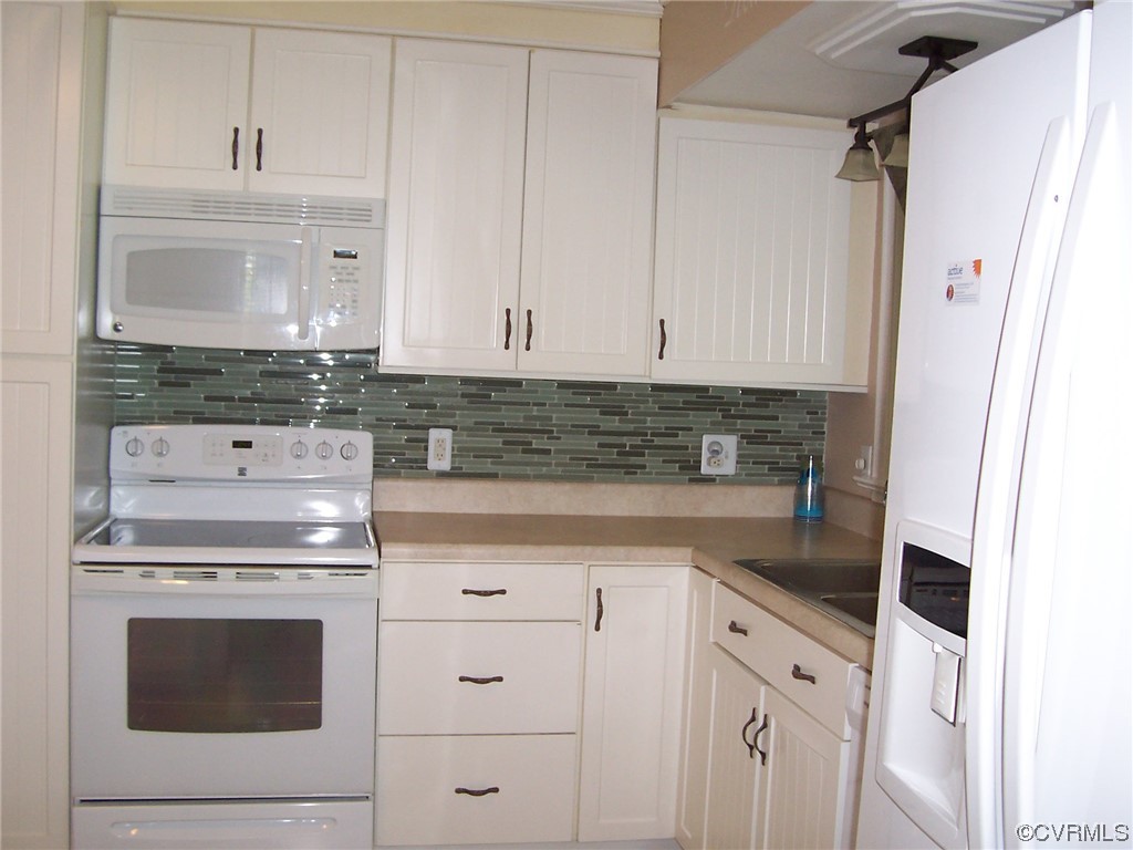 8410 Gaylord Road Henrico, VA 23229 - Photo 9 of 17 a kitchen with white cabinets and white appliances