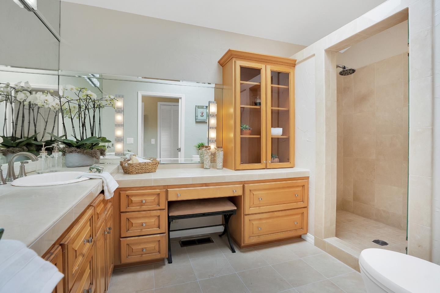 23342 Deerfield Road Los Gatos, CA 95033 - Photo 19 of 36 a bathroom with a double vanity sink a mirror a bathtub and shower