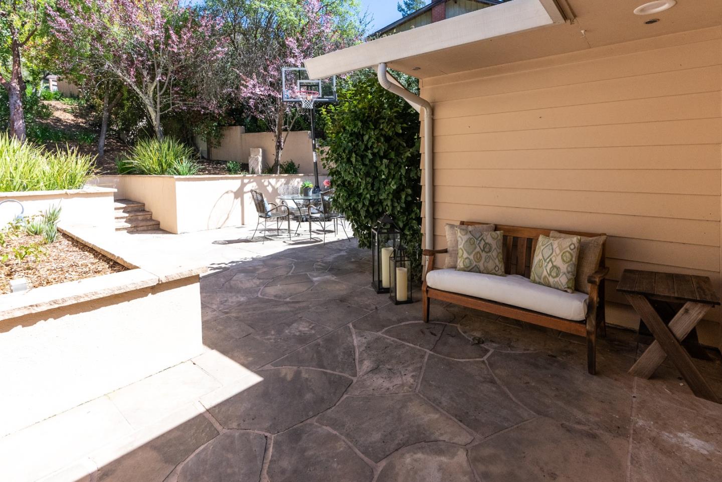23342 Deerfield Road Los Gatos, CA 95033 - Photo 25 of 36 a view of a patio with couches and table and chairs with wooden fence