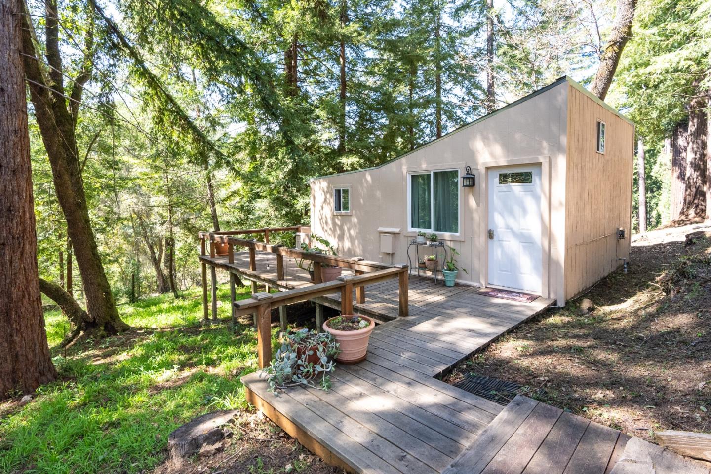 23342 Deerfield Road Los Gatos, CA 95033 - Photo 28 of 36 a view of a patio with table and chairs with wooden fence and plants
