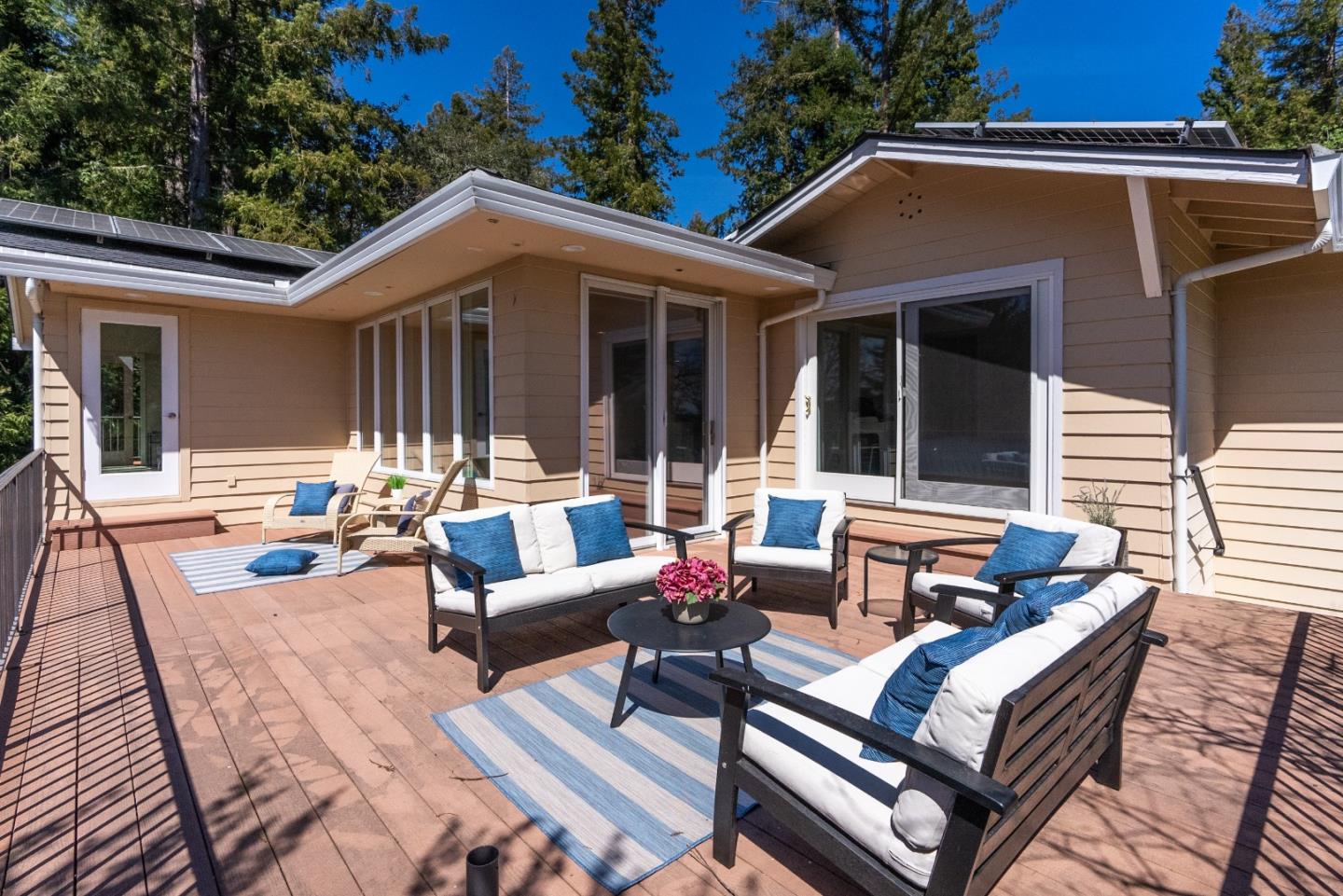 23342 Deerfield Road Los Gatos, CA 95033 - Photo 4 of 36 a view of a patio with couches table and chairs with wooden floor and fence