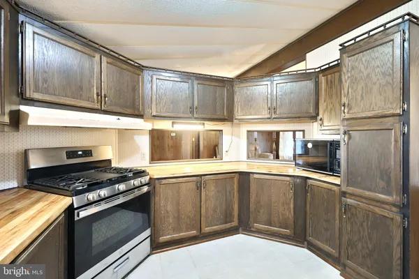 a kitchen with stainless steel appliances wooden cabinets and a sink