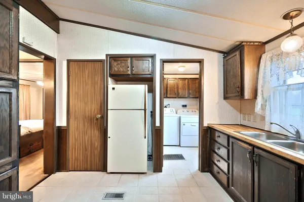 a kitchen with granite countertop a sink stainless steel appliances and cabinets