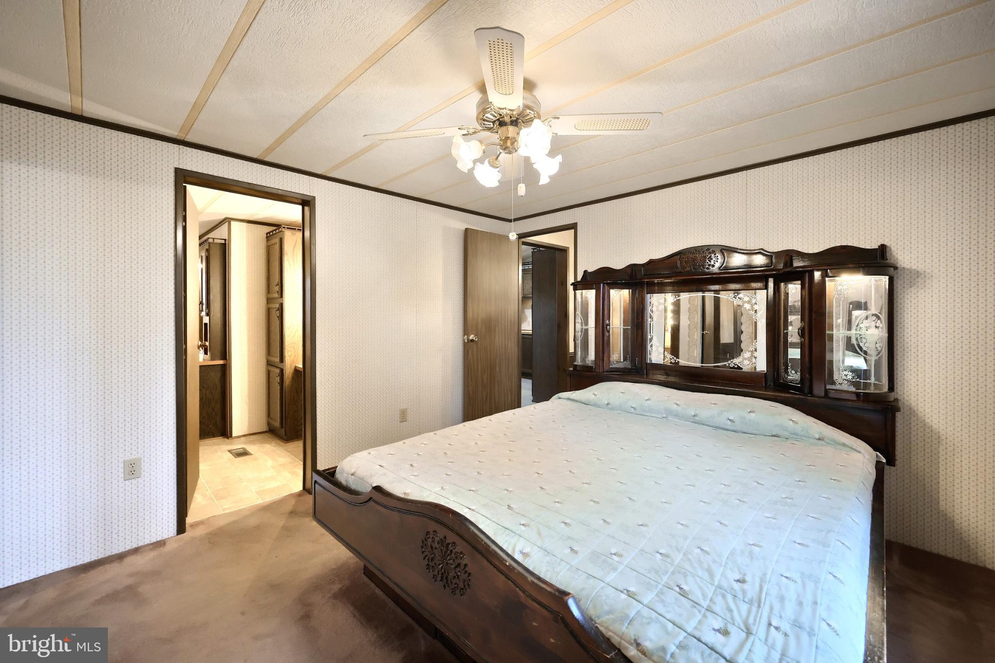 2818 Oakland Road Dover, PA 17315 - Photo 14 of 32 a bedroom with a bed and a chandelier