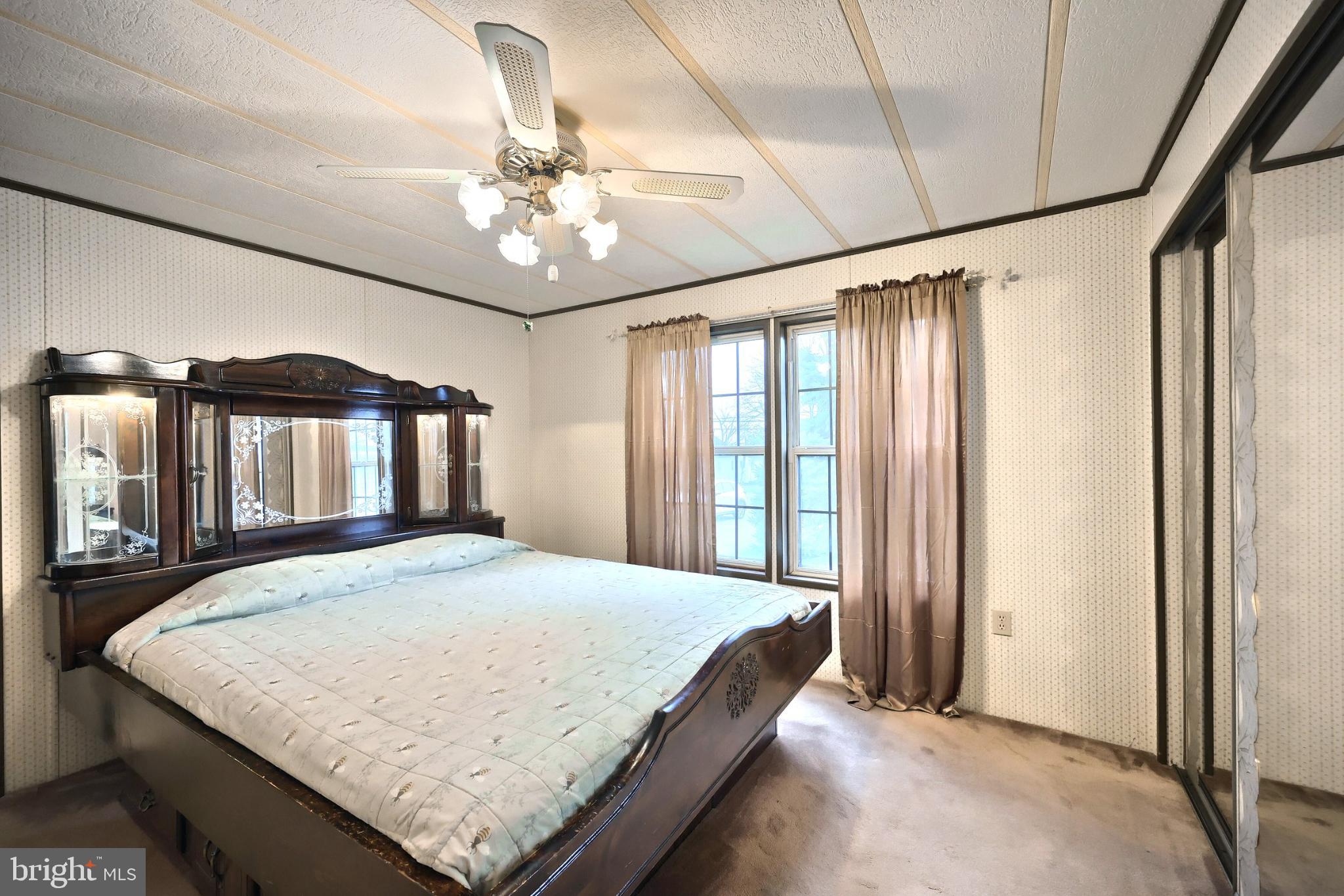 2818 Oakland Road Dover, PA 17315 - Photo 15 of 32 a bedroom with a large bed and a chandelier