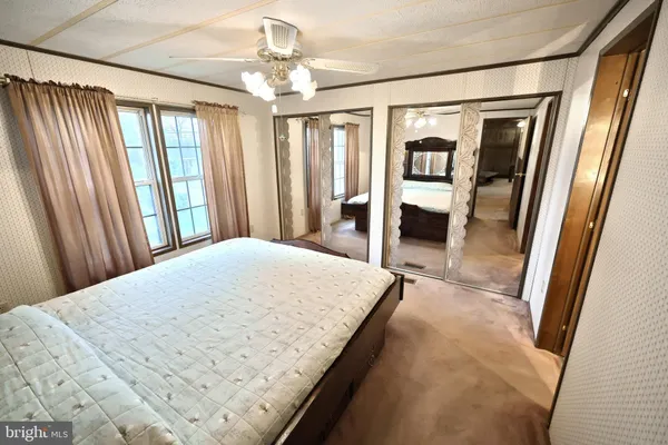 a bedroom with a large bed and a chandelier