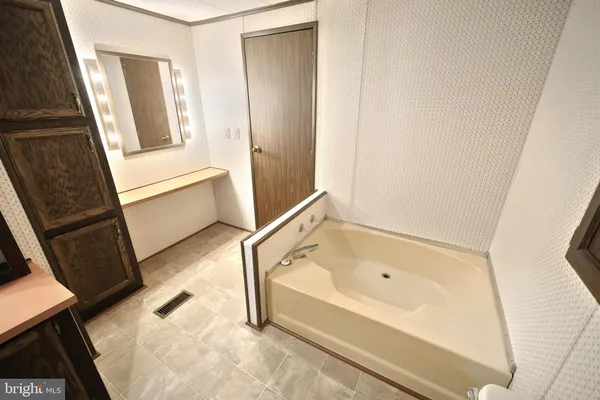 a bathroom with a mirror and a shower