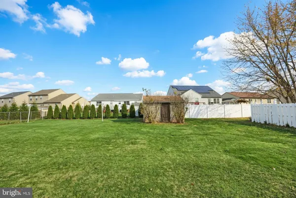 a view of a big yard with table and chairs a fire pit