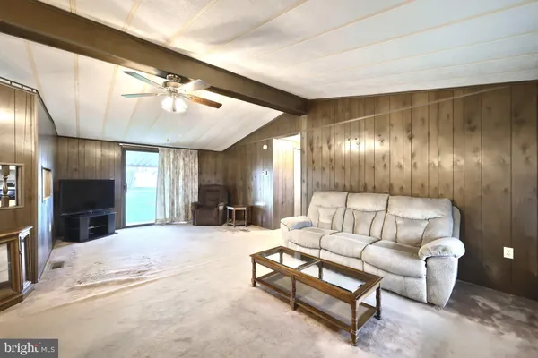 a living room with furniture a large window with outer view
