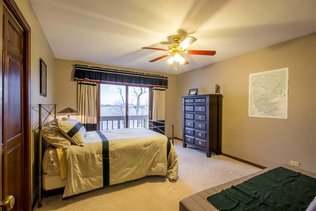 50W663 Ramm Road Maple Park, IL 60151 - Photo 15 of 25 a bedroom with a bed and a chandelier