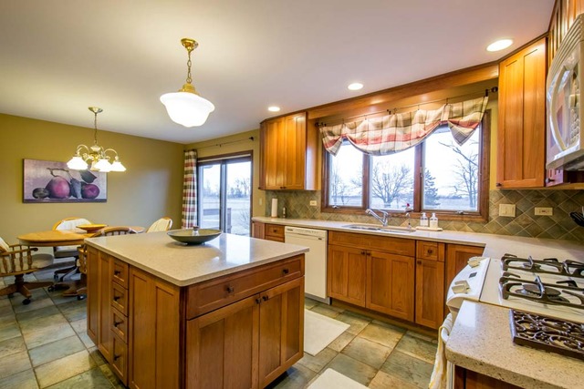 50W663 Ramm Road Maple Park, IL 60151 - Photo 7 of 25 a kitchen that has a lot of cabinets in it and a window