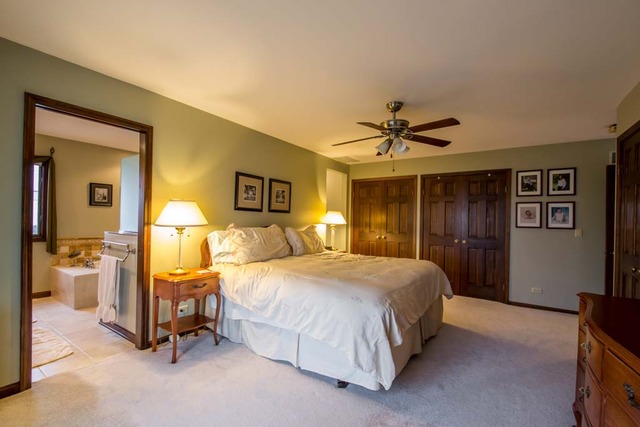 50W663 Ramm Road Maple Park, IL 60151 - Photo 8 of 25 a bedroom with a bed and a chandelier
