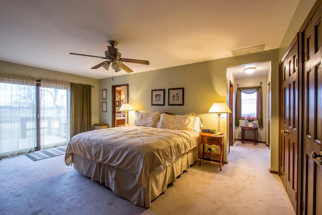 50W663 Ramm Road Maple Park, IL 60151 - Photo 9 of 25 a spacious bedroom with a bed and a chandelier