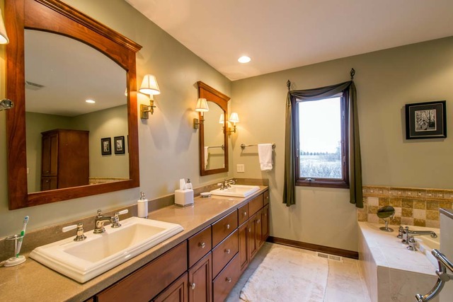 50W663 Ramm Road Maple Park, IL 60151 - Photo 10 of 25 a spacious bathroom with a double vanity sink a mirror and a bathtub