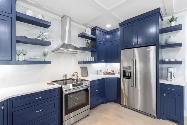a kitchen with stainless steel appliances granite countertop a refrigerator stove and sink
