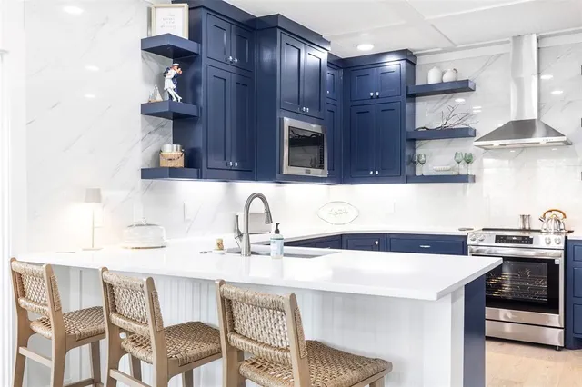 a kitchen with stainless steel appliances granite countertop a sink and a stove